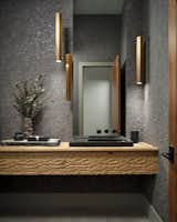 Bath Room, Stone Slab Wall, Vessel Sink, Stone Counter, and Accent Lighting  Photo 6 of 10 in Windy Pointe by Inside Stories