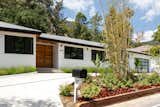 Exterior, Gable RoofLine, Stucco Siding Material, Shingles Roof Material, House Building Type, and Mid-Century Building Type Curbside View of Front Yard and Entry  Photo 3 of 15 in Mandeville Canyon - Mid Century Modern Revamp by Mark Nichols - MNichols Design