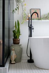 Bath Room, Enclosed Shower, Ceramic Tile Floor, Soaking Tub, Corner Shower, and Freestanding Tub  Photo 1 of 7 in Midcentury Flair takes on Small Town Texas by Aften Lane