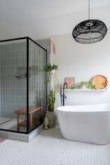 Bath Room, Freestanding Tub, Porcelain Tile Floor, Enclosed Shower, Pendant Lighting, Corner Shower, Accent Lighting, and Soaking Tub  Photo 3 of 7 in Midcentury Flair takes on Small Town Texas by Aften Lane