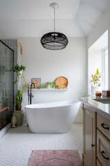 Bath Room, Porcelain Tile Floor, Undermount Sink, Corner Shower, Pendant Lighting, Freestanding Tub, Enclosed Shower, Accent Lighting, Soaking Tub, and Quartzite Counter  Photo 6 of 7 in Midcentury Flair takes on Small Town Texas by Aften Lane
