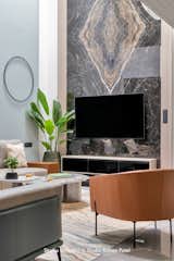 Living Room, Ceramic Tile Floor, Sofa, Media Cabinet, Chair, and Wall Lighting  Photo 15 of 38 in soham by STUDIO UNFOLD
