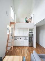 Kitchen, Wood Counter, Medium Hardwood Floor, Refrigerator, White Cabinet, and Recessed Lighting  Photo 10 of 14 in SouthE8 by LOHA