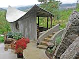 Board formed concrete outbuilding with parabolic concrete roof