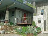 Entryway with concrete column in concrete an salvage bulldozer gears