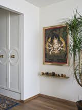 A serene master bedroom setting that features traditional Thangka artwork, complemented by a collection of mini elephants, symbolizing a journey through heritage and tranquility.