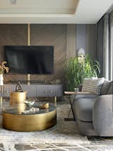An acid-finish black Turkish marble center table with a patina base adds contrast, tying together the room’s layered material palette.

