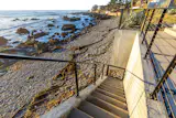 Steps lead down from the home to the beach.