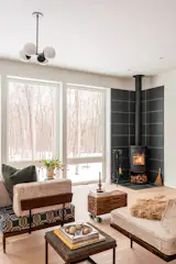 A functional Norwegian-style Morsø wood adds a cozy warmth to the living room.