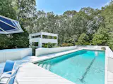 A heated 50-foot gunite pool overlooks the perennial garden and surrounding woods.