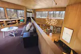 Another living room is lofted above and overlooking the primary common area.