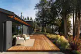 The grounds are home to mature gardens and evergreen trees.