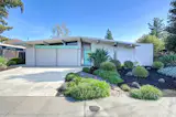 This 1965 post-and-beam Eichler home has blue-green accents, refreshed interior finishes, and a sunny central courtyard.