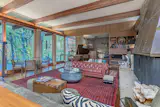 The floor-to-ceiling windows reach 12 feet high, offering a southern exposure and looking out onto the yard.