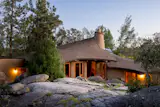 Designed by James Hubbell, Robert Thiele, and Rhoda Lopez, the organic residence has adobe walls, custom woodwork, and handmade ceramic details.