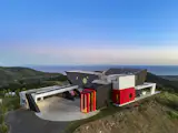 The geometric residence by Apel Design has big ocean views, a putting green, and a triangular pool.