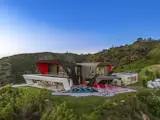 To the right of the pool is a sunken fire pit.