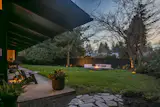 Landscape architect Chandler Fairbanks’s original design has been updated with a clover lawn, a gas firepit, and raised garden beds.
