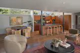 Clerestory windows face opposite the floor-to-ceiling wall of glass, allowing a double exposure in the main living room.