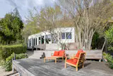 This 2015 property is perched on stilts, and it comes with an ample patio and an open-plan living area wrapped in floor-to-ceiling glass.