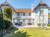 The home’s roof is topped with colorful shingles that form a geometric pattern.