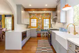 The current owner, creative director Elizabeth Spiridakis,&nbsp;revamped the the kitchen herself. The&nbsp;hardware and lighting are by Schoolhouse.