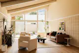 Floor-to-ceiling windows bring natural light into the living areas of the post-and-beam homes.