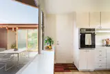A serving hatch connects the courtyard patio and kitchen.