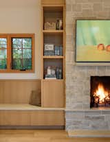 Fireplace, bookshelf, and stone bench