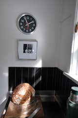 We decided against ripping out the old kitchen, instead just restoring a stainless steal bench-top as it would have had originally & making the minor practical addition of a tiled splash-back.