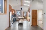 Kitchen with cabinets, table, door milled from tree felled on-site.
