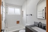 One of two full bathrooms with built-in cabinetry and shelving niches