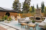 The backyard was transformed into a space for entertaining with different zones to dine, lounge and relax. The large addition of the double car garage in the back mimics the front with the circular window to make it feel more enclosed and a part of the architectural envelope of the home. 