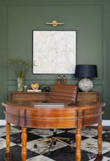 A mix of modern and traditional elements in the home like the simple wall detailing in the office, helps to make the spaces feel more intimate. A mix of antiques also helps to pull the spaces together. 
