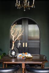 Custom doors block off the studio space from the auxiliary room. Painted a rich green, it helps to unify the homes organic interiors.