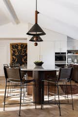 The open concept kitchen is a cooks dream and a large island is perfect for intimate dinners. The curved portion on the one end allows it to feel less monolithic. 