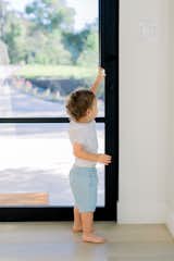Little boy reaches to open RAM pivot door.