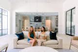 Two women sit and chat in beautiful, transitional home in West Lake Hills, Austin with RAM picture windows.  