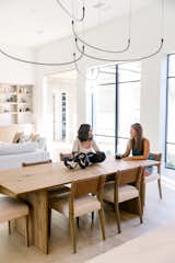 Two women sit and chat in beautiful, transitional home in West Lake Hills, Austin with RAM picture windows. 