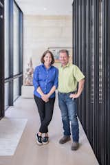 The architects, Mark Schatz and Anne Eamon and Anne Eamon of m+a Architecture pose in the entryway of this modern Houston home.