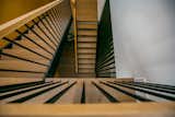 Natural wood stairs accented with metal balusters.