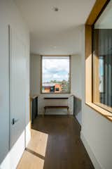 RAM picture window surrounded with natural wood frames the outdoor Houston view.