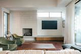 RAM picture windows illuminate this modern living room accentuated with natural wood.