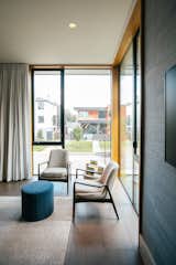 RAM casement and picture windows allow natural light into the reading corner of this modern bedroom.