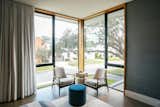 RAM casement and picture windows allow natural light into the reading corner of this modern bedroom.