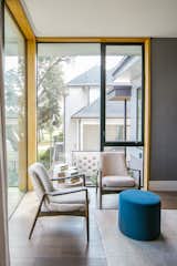 RAM casement and picture windows allow natural light into the reading corner of this modern bedroom.