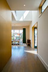 RAM picture windows illuminate this modern hallway accented with natural wood.