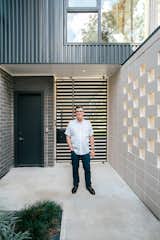 Award winning architect, Brad Hollenbeck, stands next to his AIA-award Houston home featuring RAM picture and casement windows.
