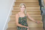 Nancy Bender of Brandie Homes poses on the wooden staircase in her new build in the Dallas area.