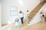 A family enjoys the natural light of this home thanks to large RAM windows and doors.